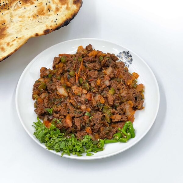 A traditional Yemeni breakfast dish made with fava beans, tomatoes, onions, and a blend of spices. The ingredients are cooked together in a pot until the mixture reaches a thick, creamy consistency.